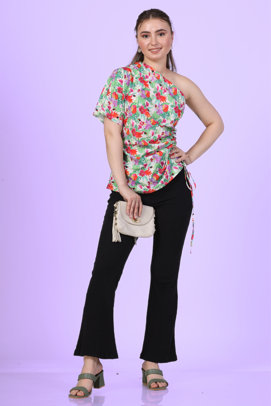 Front view of a model wearing the one shoulder kimono top paired with trousers