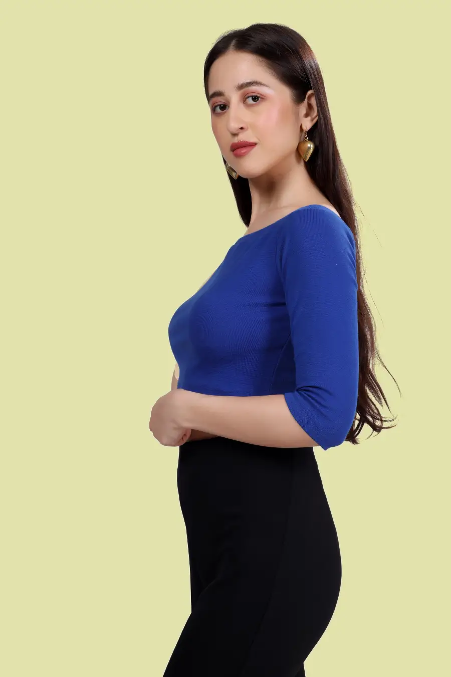 Side view of model wearing the 'Mia' Off Shoulder Top, featuring an elegant off-shoulder design and fitted bodice