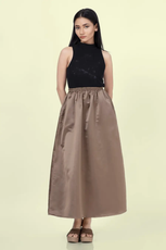 a woman in a black tank top and a brown gathered skirt sewed with winslets patterns