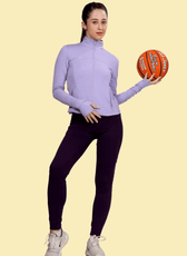Model posing with a basketball while wearing the Venus sports jacket, demonstrating its flexibility and suitability for active lifestyles.