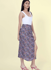 Side view of the 'Dahlia' midi skirt sewing pattern, showcasing its elegant drape and high slit. Ideal for DIY fashion enthusiasts.