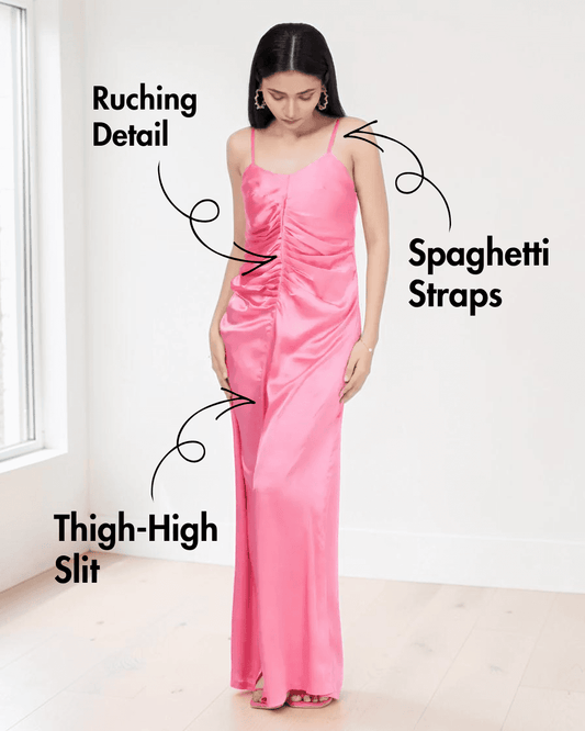 Back view of pink satin slip dress with spaghetti straps and high slit