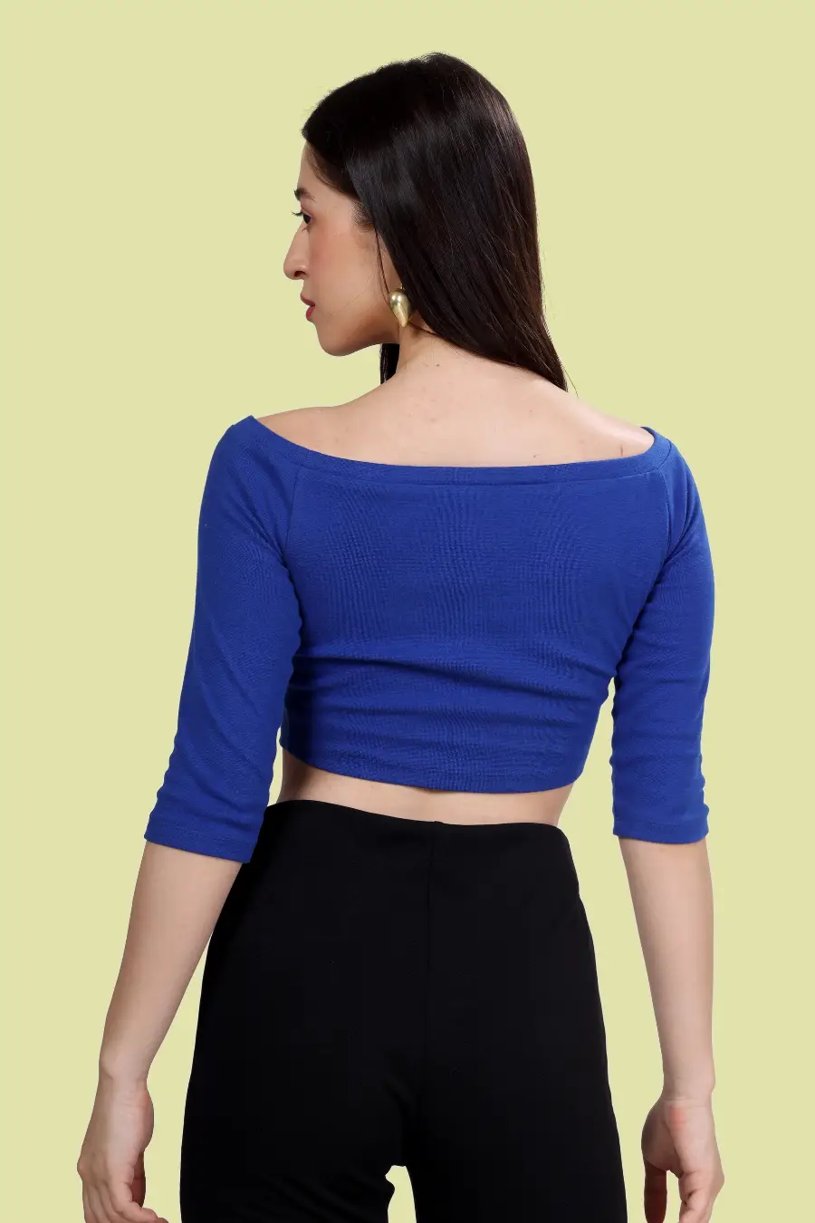 Back view of model wearing the 'Mia' Off Shoulder Top, featuring an elegant off-shoulder design and fitted bodice