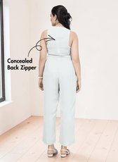 Back view of a woman in a black patterned jumpsuit with concealed back zipper