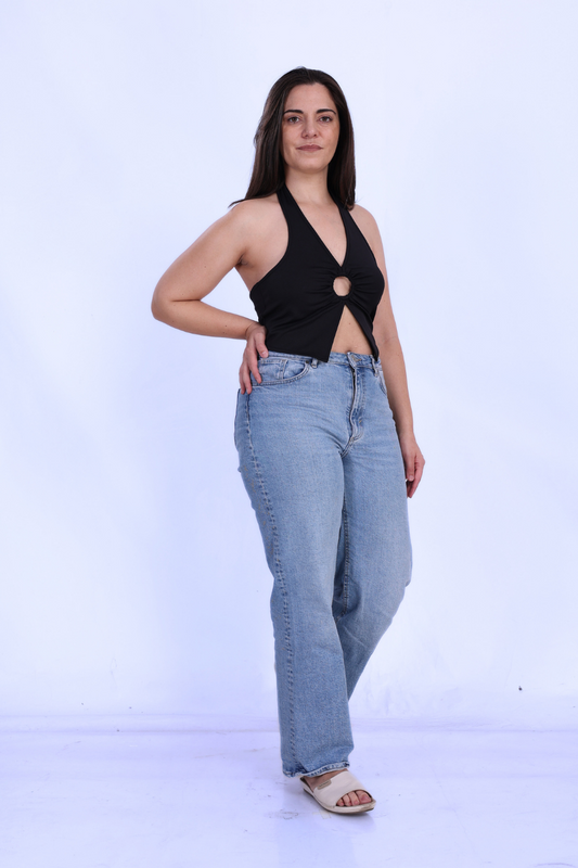 Model wearing the 'Winx' Halter Neck Top, a chic cut-out crop top with a flattering fit. Ideal for casual or evening wear, made from stretch fabric.