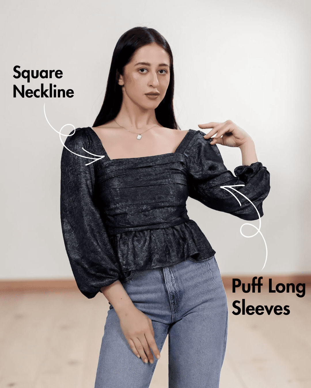 Women's black gathered peplum hem sewing pattern with smocked back and puff long sleeves, front view