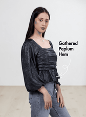 Women's black gathered peplum hem sewing pattern with smocked back and puff long sleeves, side view