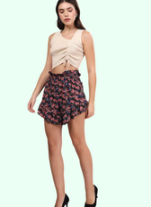 Model posing in ruffle hem shorts with a smocked waistband. The relaxed fit and ruffle details add a playful, stylish touch.