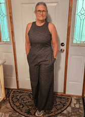 Customer wearing a fitted jumpsuit with back zipper and wide-leg pants for formal wear