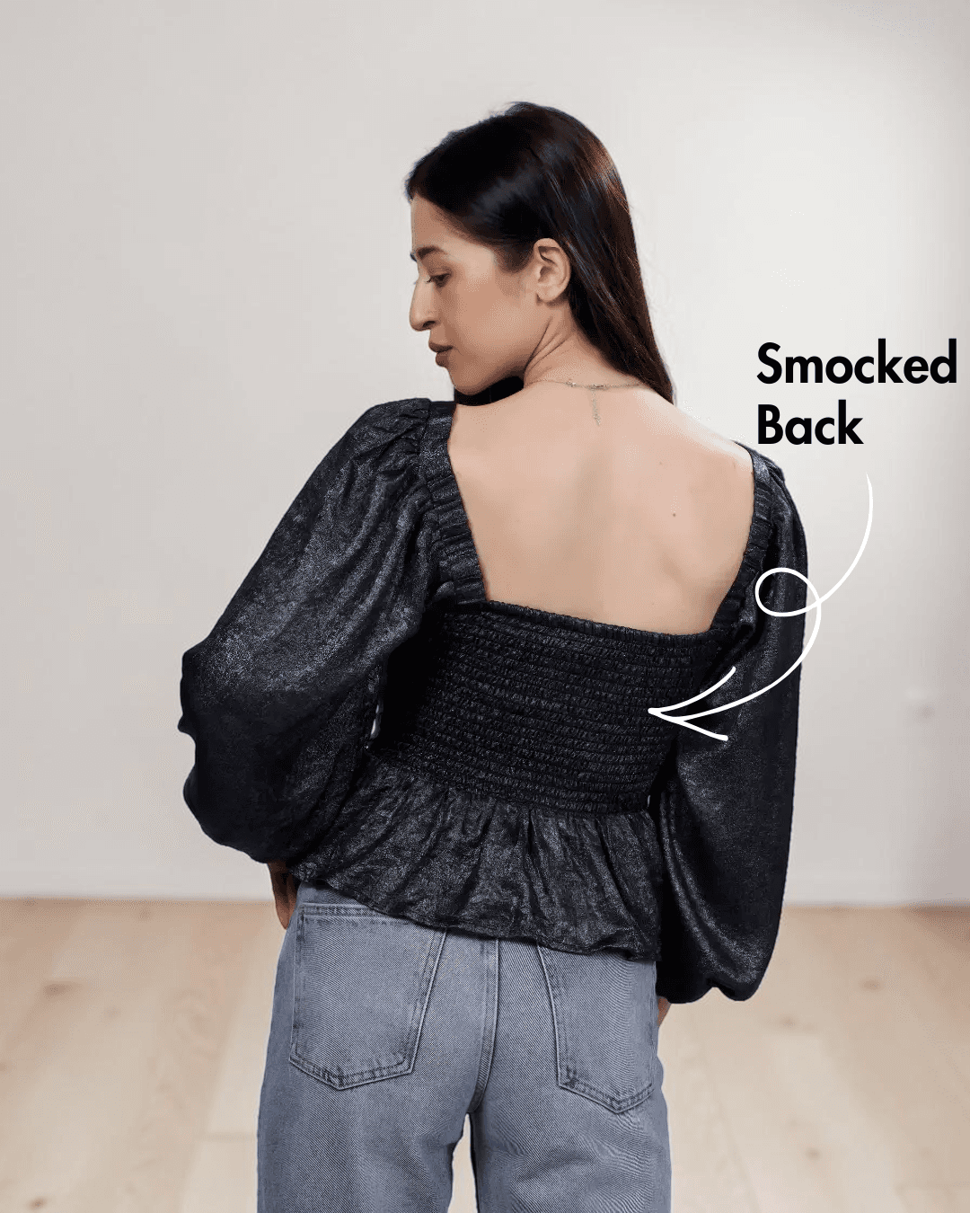 Women's black peplum top sewing pattern with square neckline and puff long sleeves, back view