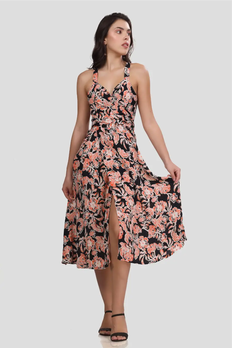 Front view of the 'Camellia' wrap dress showcasing a sweetheart neckline, cross-back straps, and a front slit. The flowing skirt adds graceful movement.
