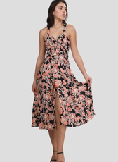 Front view of the 'Camellia' wrap dress showcasing a sweetheart neckline, cross-back straps, and a front slit. The flowing skirt adds graceful movement.