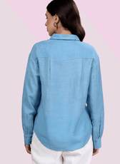 Back view of the 'Hayden' oversized shirt. Highlights the back yoke with pleat detail, long sleeves, and curved hem for a comfortable, stylish fit.