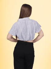 a woman wearing a striped shirt and black pants designed with winslets patterns