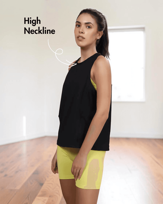 Model wearing black sleeveless tank top with high neckline, paired with yellow shorts, showcasing 'Tracy' sewing pattern for activewear