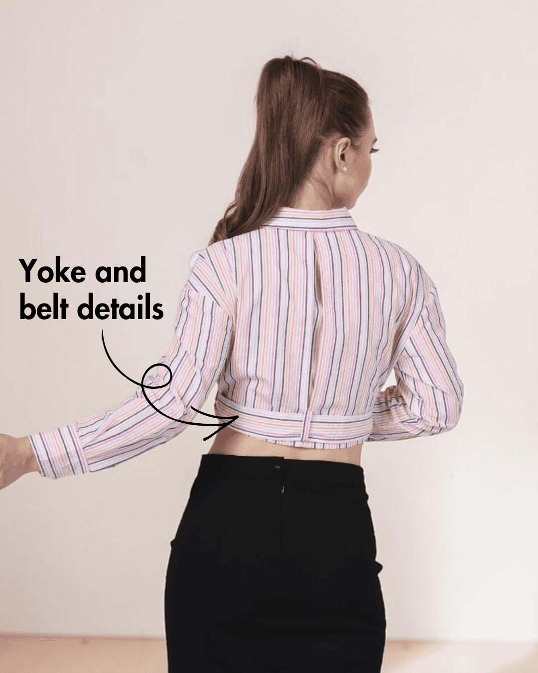 Back View of women's plaid belted cropped shirt with collar, buttons, and belt detail