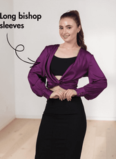 Side view of purple satin ruched twist front crop top with long bishop sleeves