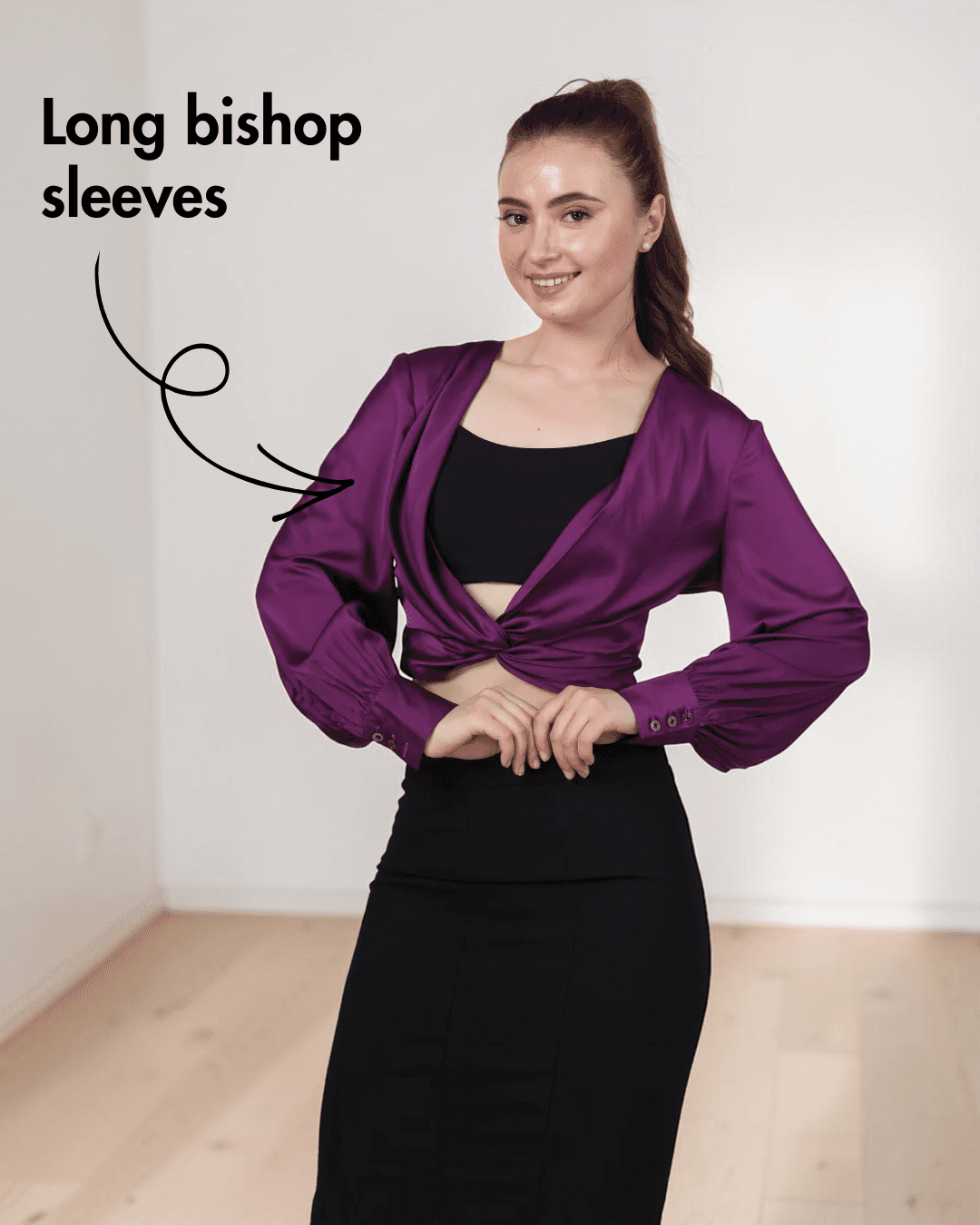 Side view of purple satin ruched twist front crop top with long bishop sleeves
