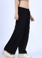 Close-up side view of black Y2K sweatpants made with the 'Maddie' sewing pattern. Features large cargo pockets and a wide-leg silhouette.