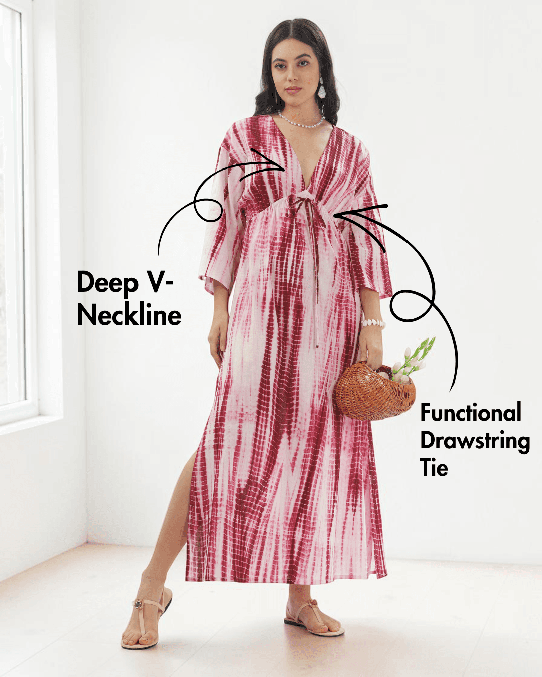 Model wearing pink and red tie-dye kaftan dress with deep V-neckline and wide three-quarter sleeves