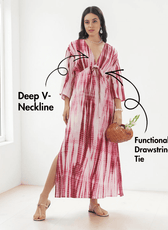 Model wearing pink and red tie-dye kaftan dress with deep V-neckline and wide three-quarter sleeves