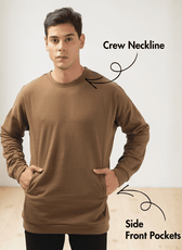 Model wearing men's brown crewneck sweatshirt sewing pattern with long sleeves and subtle panel details