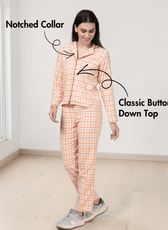 Model wearing peach plaid pajama top with notched collar and elastic waistband pants