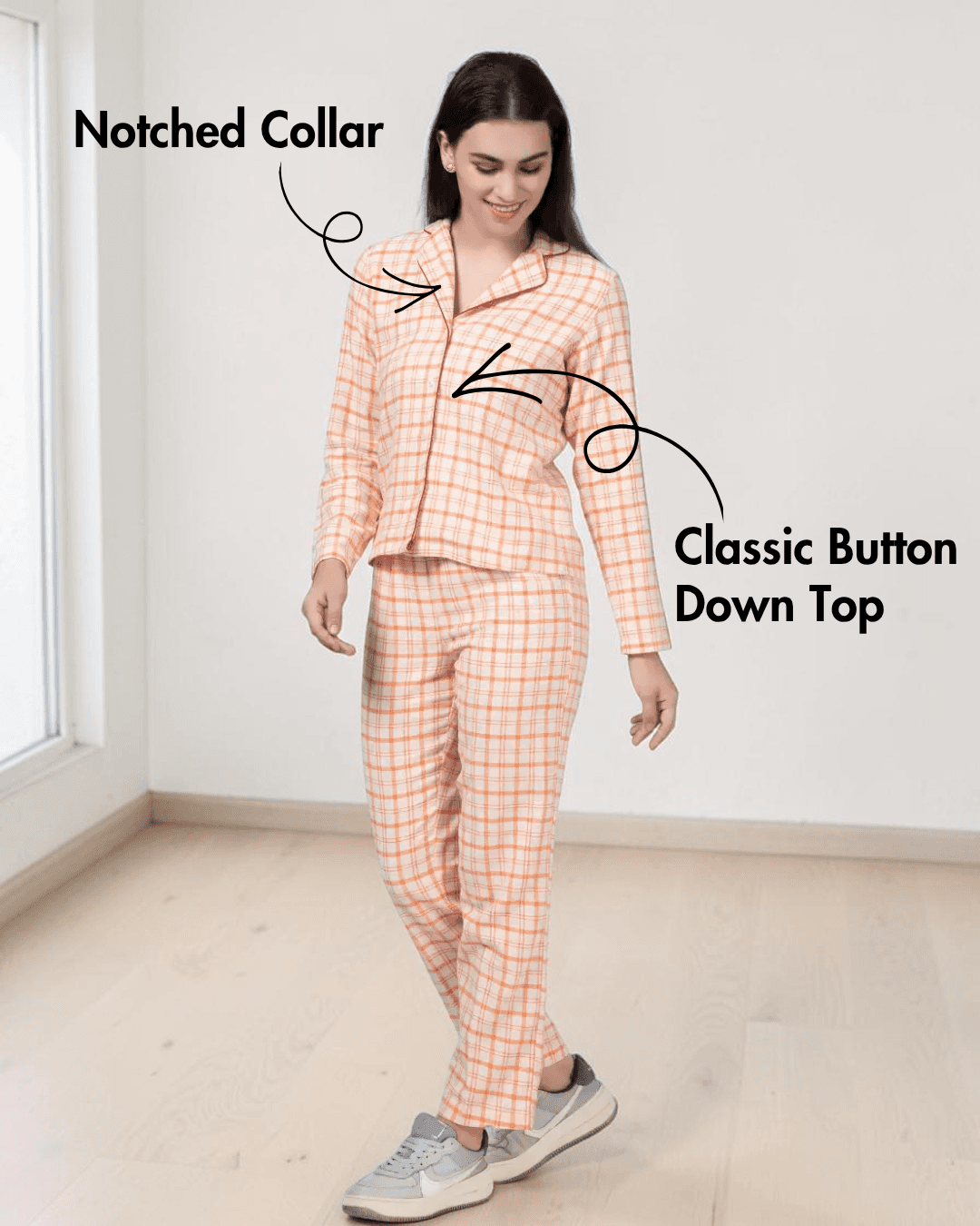 Model wearing peach plaid pajama top with notched collar and elastic waistband pants