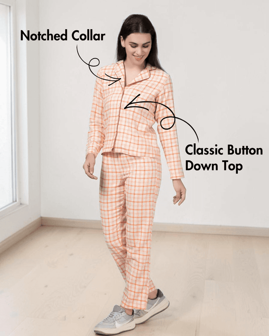 Model wearing peach plaid pajama top with notched collar and elastic waistband pants