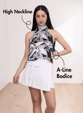 Model wearing high neckline halter top with A-line bodice and minimal back design