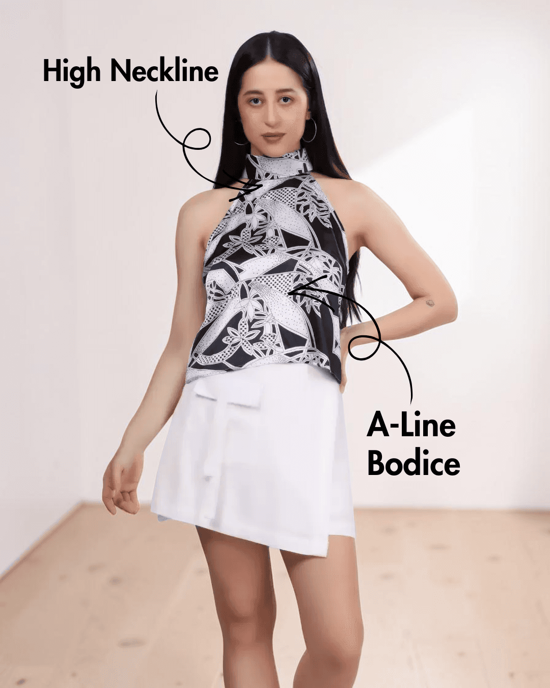 Model wearing high neckline halter top with A-line bodice and minimal back design