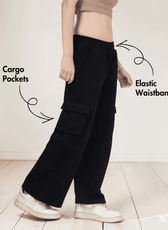 Close-up of black cargo sweatpants with cargo pockets and elastic waistband