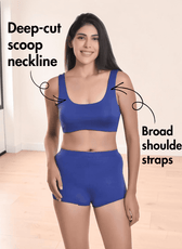 Woman wearing blue sports bikini top with broad shoulder straps and high-waisted shorts