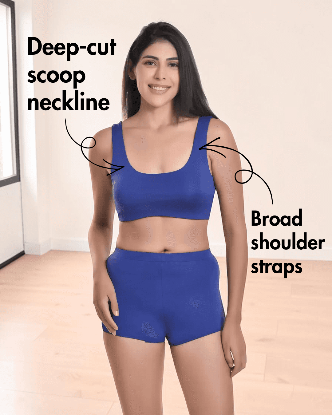 Woman wearing blue sports bikini top with broad shoulder straps and high-waisted shorts