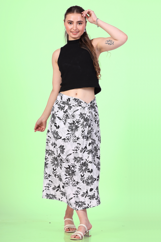Woman wearing a twist knot skirt with a black tank top