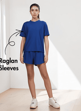Model wearing blue activewear set with raglan T-shirt and shorts