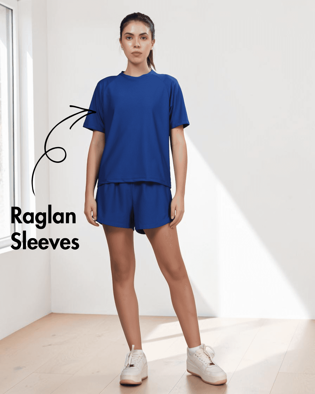 Model wearing blue activewear set with raglan T-shirt and shorts