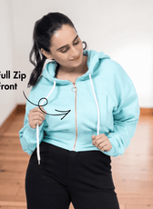 Close-up of woman in light blue zip-up hoodie with full front zipper, highlighting the sewing pattern details for a women's crop jacket