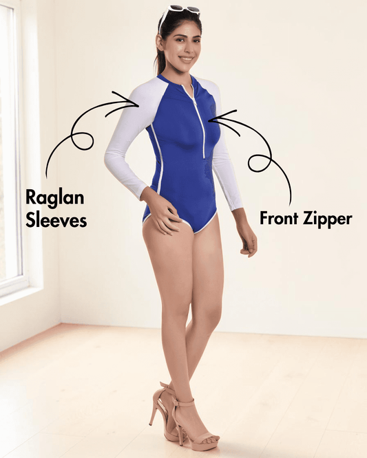 Model wearing blue and white long sleeve swimsuit with zipper