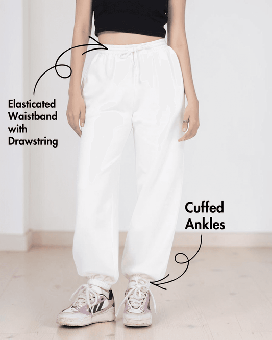 Close-up of white joggers with elastic waistband and cuffed ankles, showcasing sewing pattern details