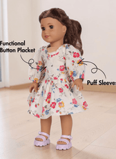 Side view of doll Millie in floral dress with elastic shirring and puff sleeves