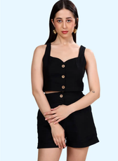 Model wearing the 'Harper' cropped waistcoat in black with a button-down front. A stylish sleeveless top sewing pattern for a modern, fitted look.