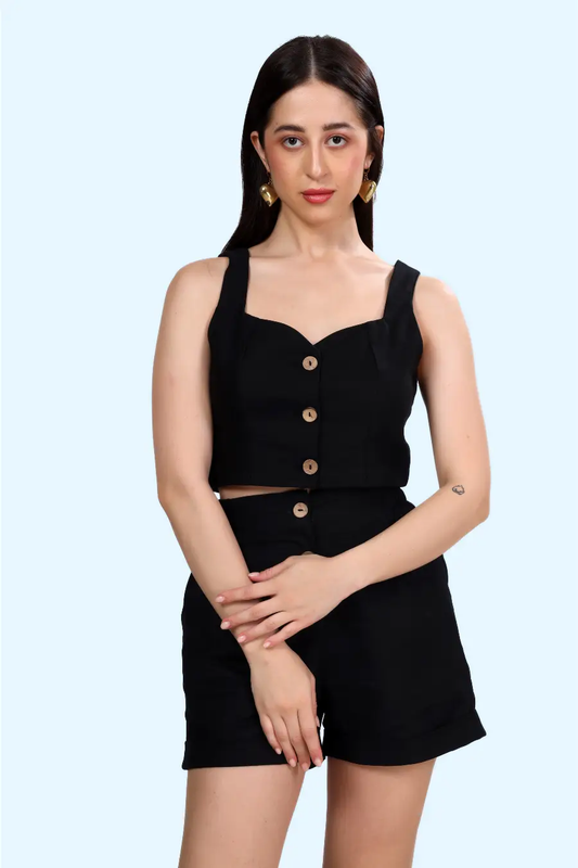 Model wearing the 'Harper' cropped waistcoat in black with a button-down front. A stylish sleeveless top sewing pattern for a modern, fitted look.