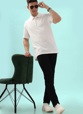 Full-body shot of a model wearing a men's polo shirt from the 'John' sewing pattern. Styled with black pants and white sneakers for a modern look.