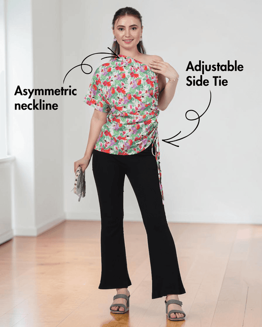 Model wearing floral one shoulder kimono top with adjustable side tie, black pants, and heels, sewing pattern for women