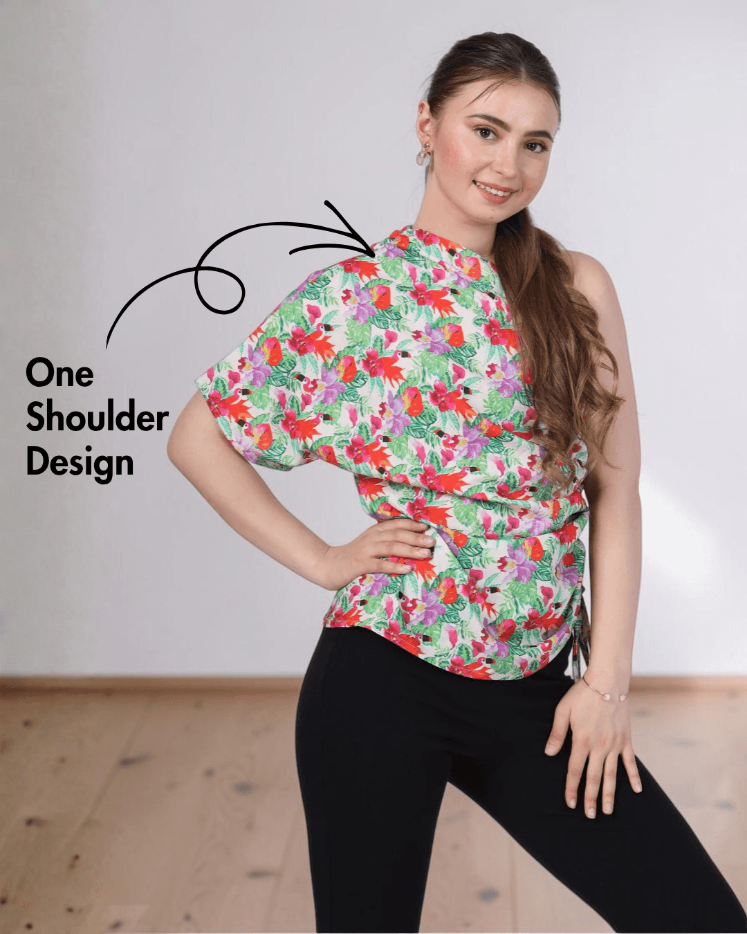 Close-up of floral one shoulder kimono top with asymmetric neckline, side tie detail, and pattern design