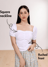 Close-up of white puff sleeve top with ruched front detail and square neckline