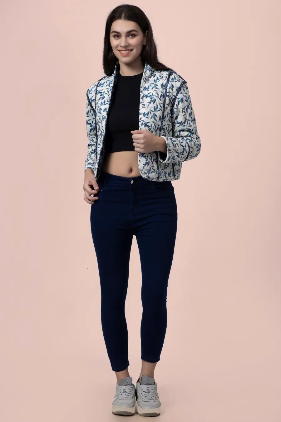 Front view of the Romy reversible quilted jacket in a blue and white leaf pattern. A chic, hip-length outerwear design with structured contrast binding.