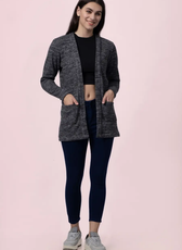 Model wearing a long open-front cardigan made using the 'Nora' sewing pattern. Features a relaxed fit, long sleeves, and front pockets for a stylish layering option.
