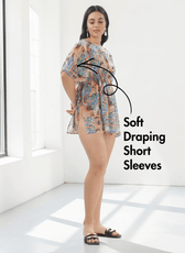 Model in colorful kaftan with soft draping short sleeves and wide boat neckline